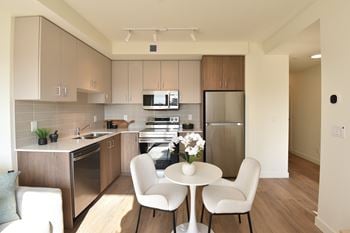 A kitchen with a table and chairs